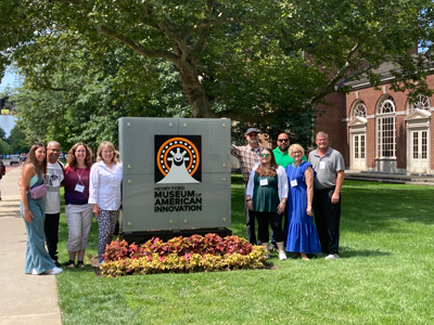 Teacher Innovator Award Winners for 2023 outside of Henry Ford Museum of American Innovation standing on the lawn in front of the sign