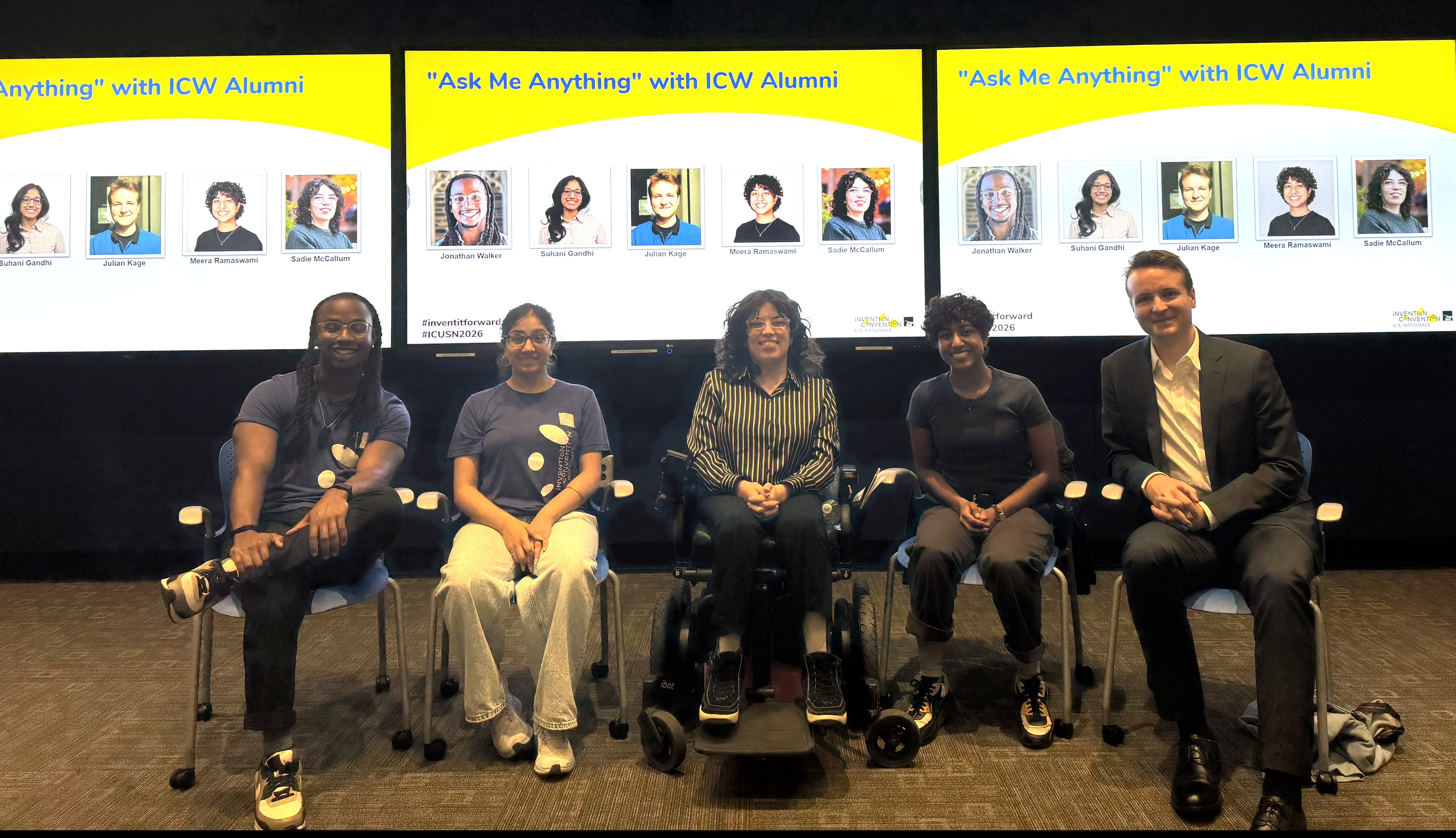 Edited alumni panel Five people sitting in chairs in front of a screen that features their photos and the title