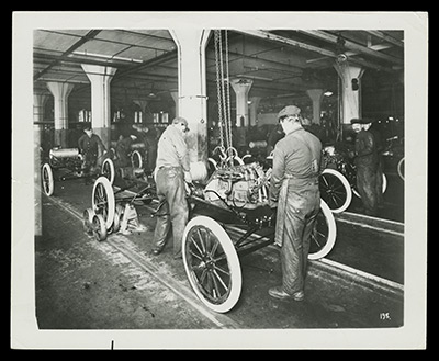 Ford Model T assembly line, as described in the text.